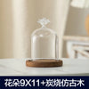 Clear glass aromatherapy candle holder with a decorative top and a wooden base.
