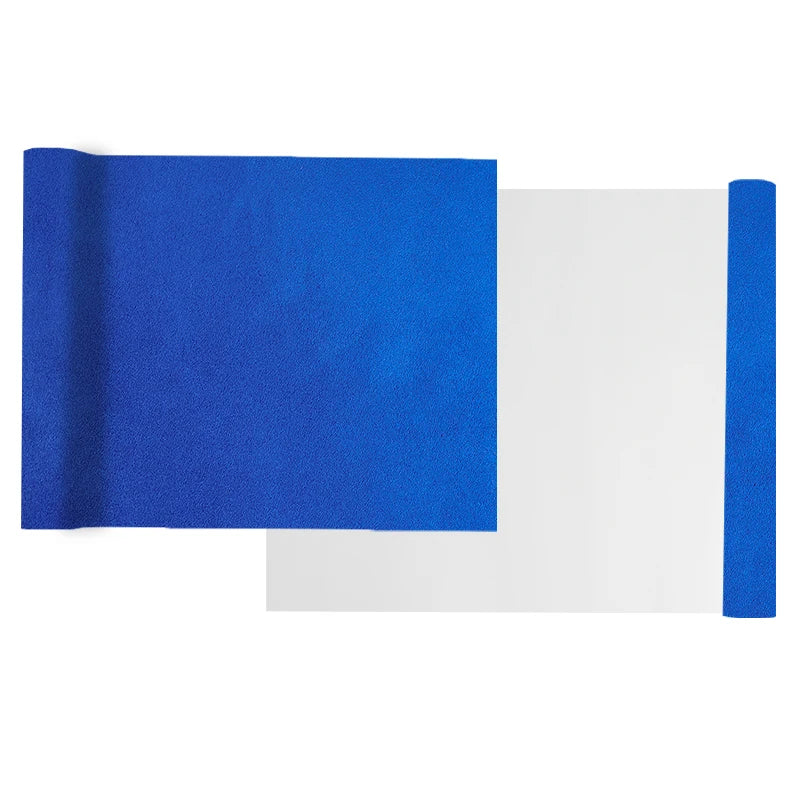 A roll of blue suede wrap fabric next to a sheet of white material for DIY projects.