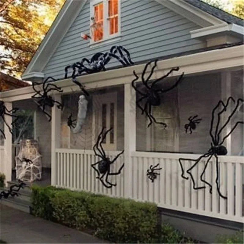 A black spider decoration is displayed on the siding of a house under a pitched roof.