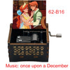 A hand-cranked wooden music box featuring an illustration of two characters, labeled 62-B16.