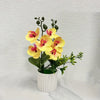 Artificial yellow phalaenopsis orchid with pink accents in a white pot