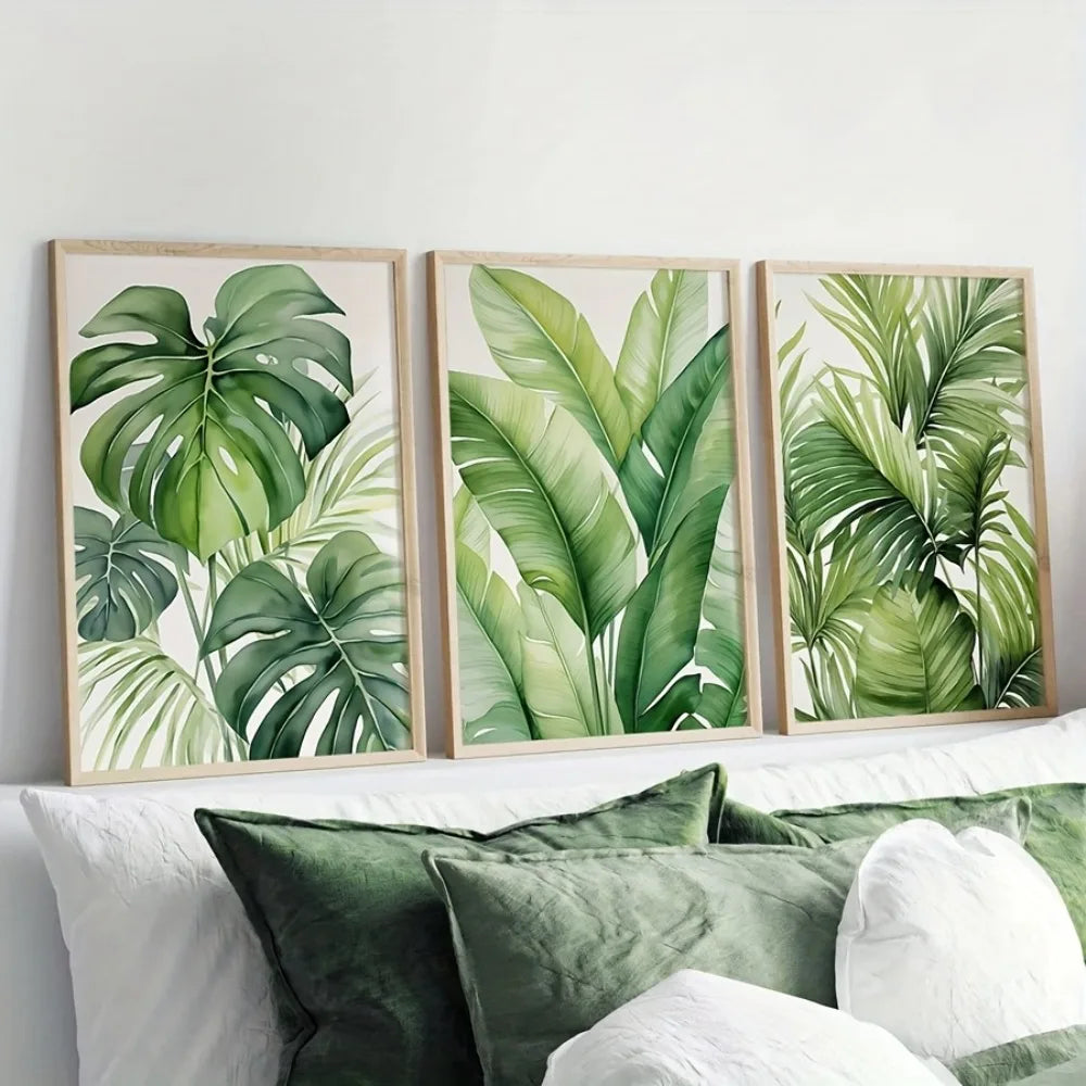A set of three framed watercolor prints featuring lush green tropical leaves on a white background.