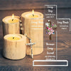Wooden candles and an acrylic cross with Bible verses displayed on a wooden surface.
