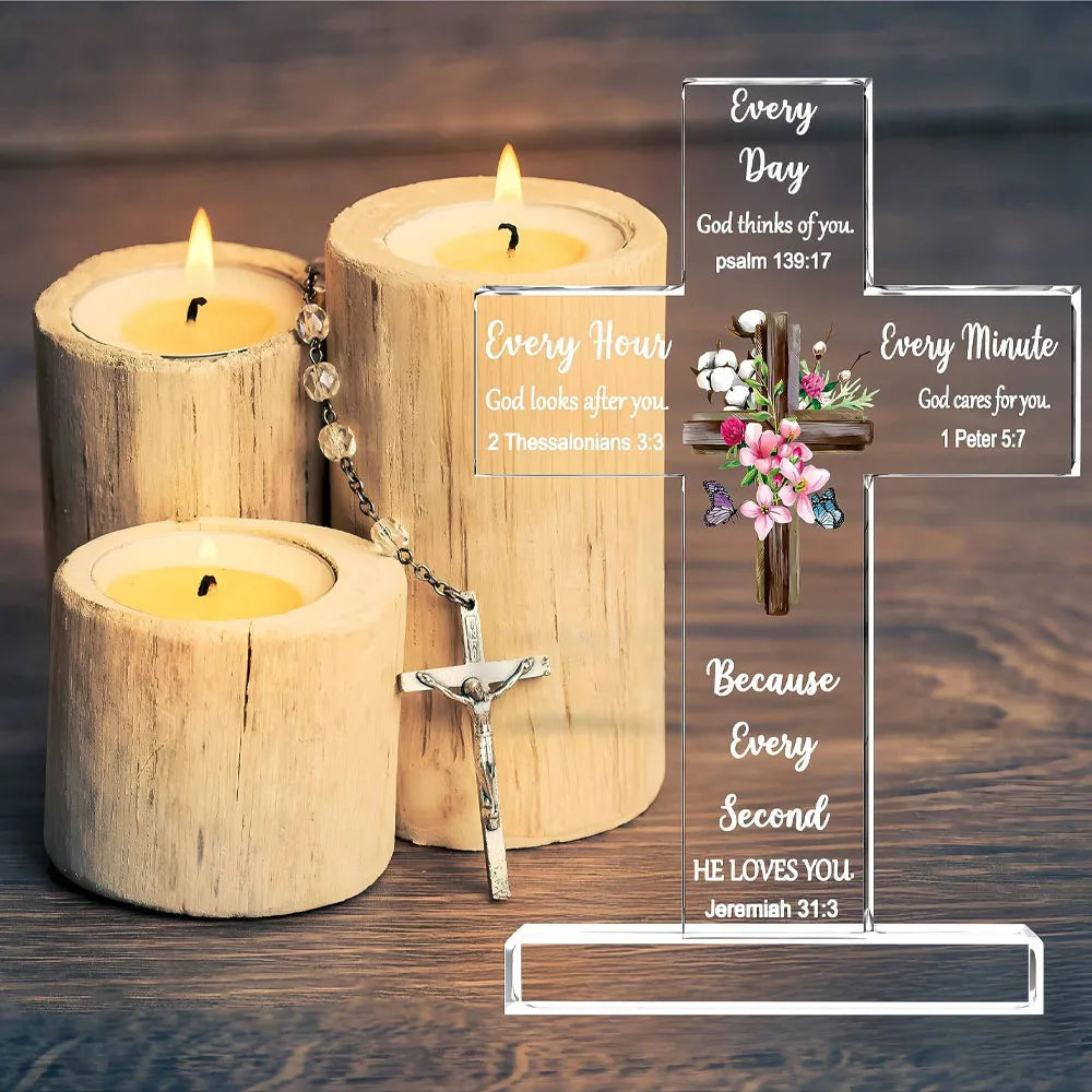Wooden candles and an acrylic cross with Bible verses displayed on a wooden surface.
