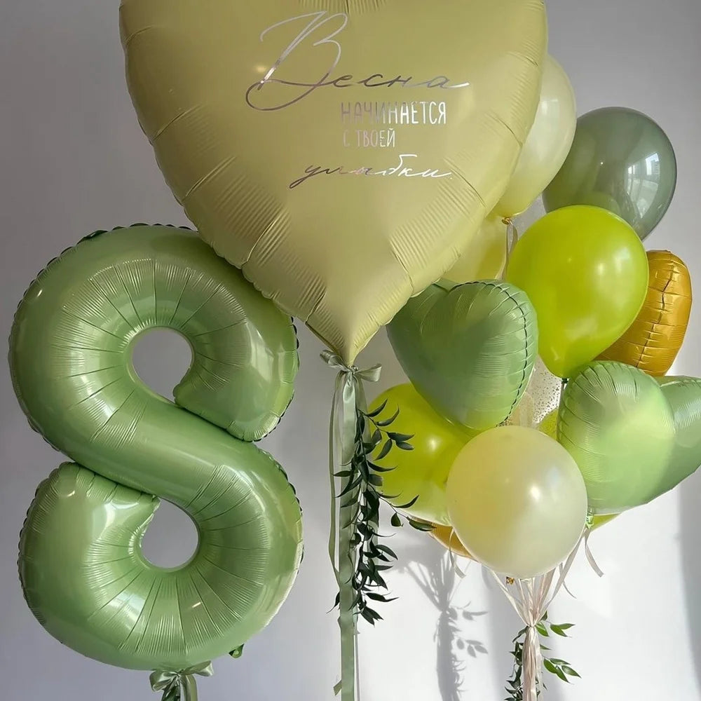 A bouquet of vintage number balloons shaped like the letter B and various green and yellow balloons for birthday decor