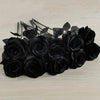 A dark arrangement of artificial black roses and leaves for home decor.