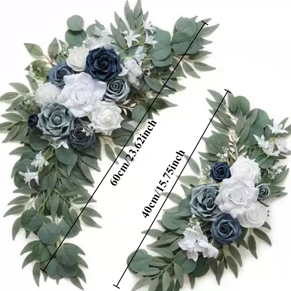 A floral kit featuring dusty rose and blue eucalyptus greenery with white and dark blue roses for a wedding arch.