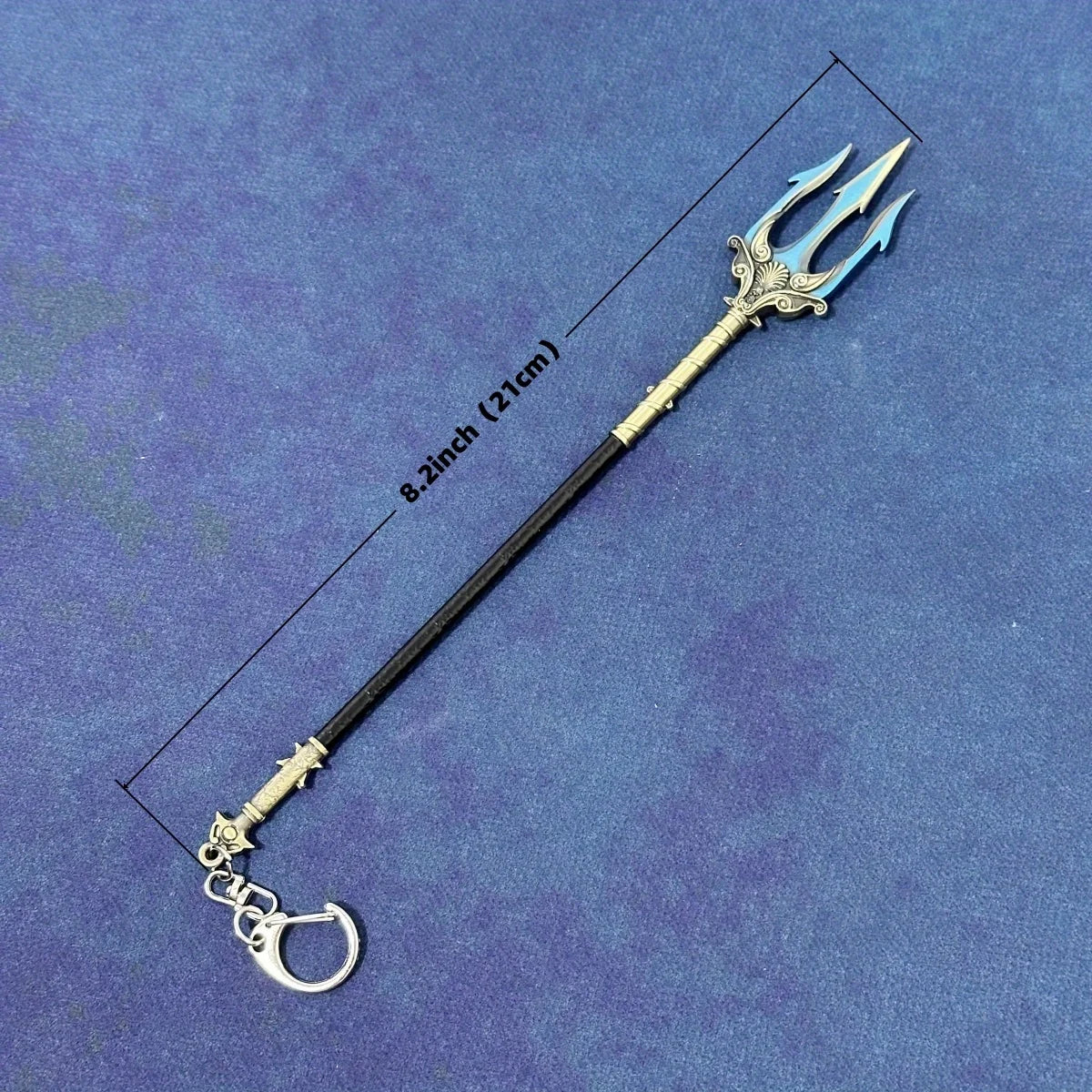 A black miniature sword resembling a Katana with a stylized blue blade and silver hilt, shown against a purple background.