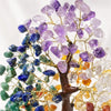 A bendable crystal tree ornament featuring various purple, blue, green, and amber colored crystals.