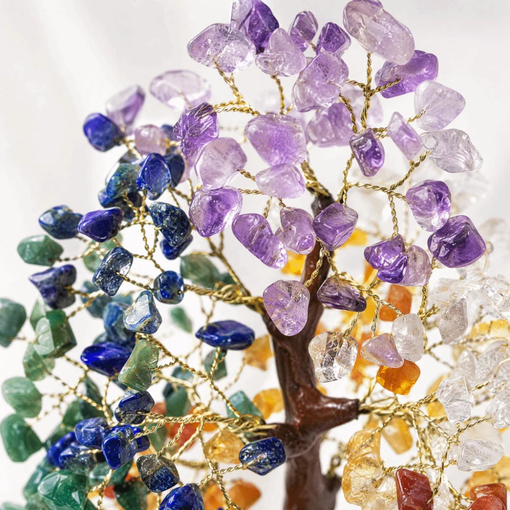 A bendable crystal tree ornament featuring various purple, blue, green, and amber colored crystals.