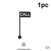 A black desk sign featuring a call indicator and a back off indicator, with self-adhesive tape.
