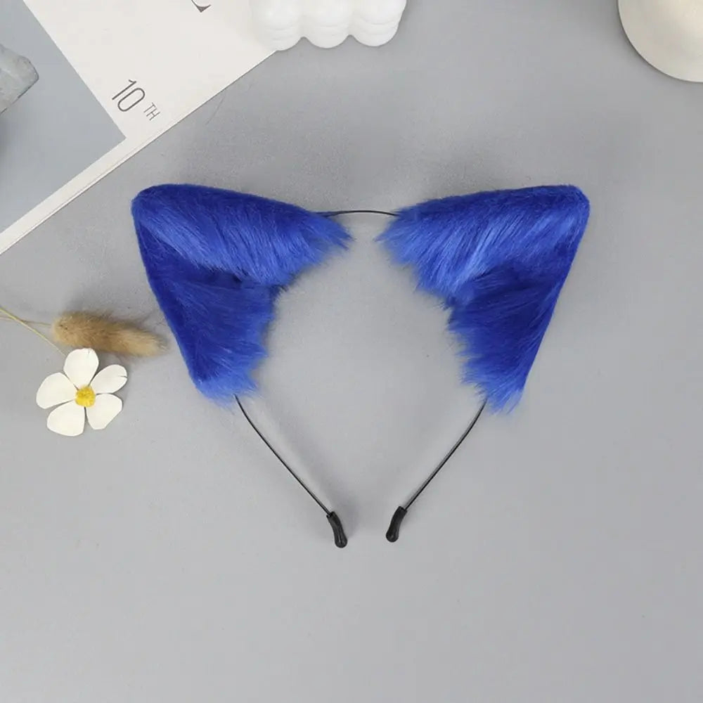 A pair of deep blue plush fox ears headband with black elastic straps and a small white flower decoration.