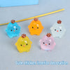 A collection of colorful luminous resin chicken ornaments in shades of blue, orange, yellow, and pink.