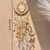 Gold star moon wind chime featuring clear crystals and gold accents hanging against a light background.