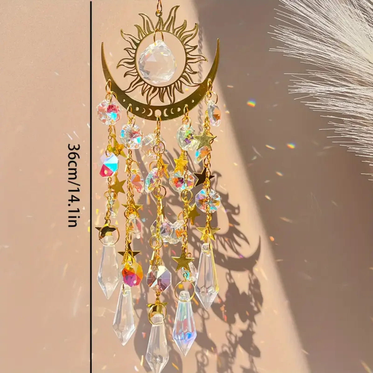 Gold star moon wind chime featuring clear crystals and gold accents hanging against a light background.