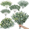 A collection of artificial eucalyptus leaves and greenery arranged in various bouquets for home decor.