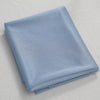 A folded piece of light blue chiffon fabric used for wedding arch drape.