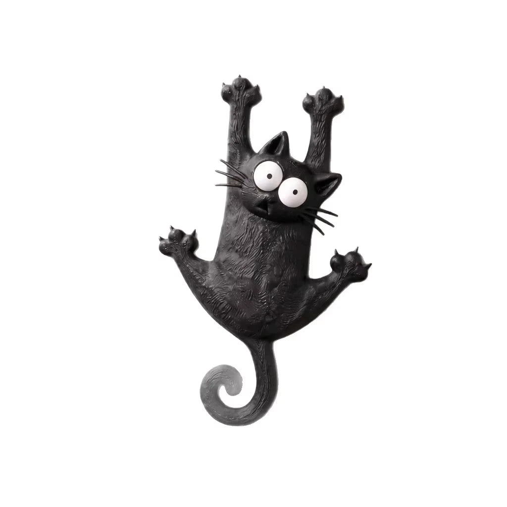 Schwarze, skulptierte Katzenfigur mit großen Augen und auffälligen Schnurrhaaren, als Kühlschrankmagnet gestaltet.