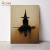 Minimalist witch silhouette wall art featuring a black witch figure with a pointed hat against a warm, golden background.
