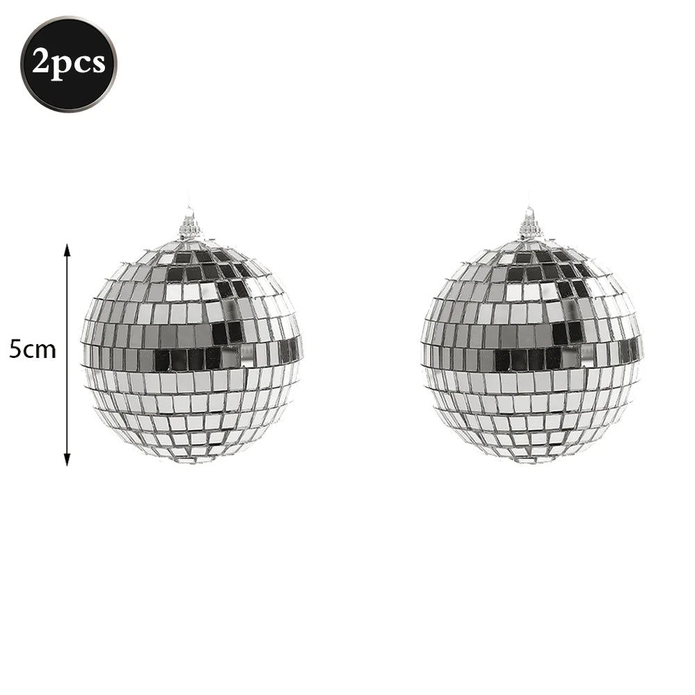 Two silver disco mirror balls, 5cm in diameter, for parties and decor.