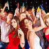 A group of people raising party syringes in a celebratory atmosphere.