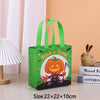 A bright green non-woven gift tote bag with a Halloween pumpkin print and a rabbit design, displayed on a wooden surface.