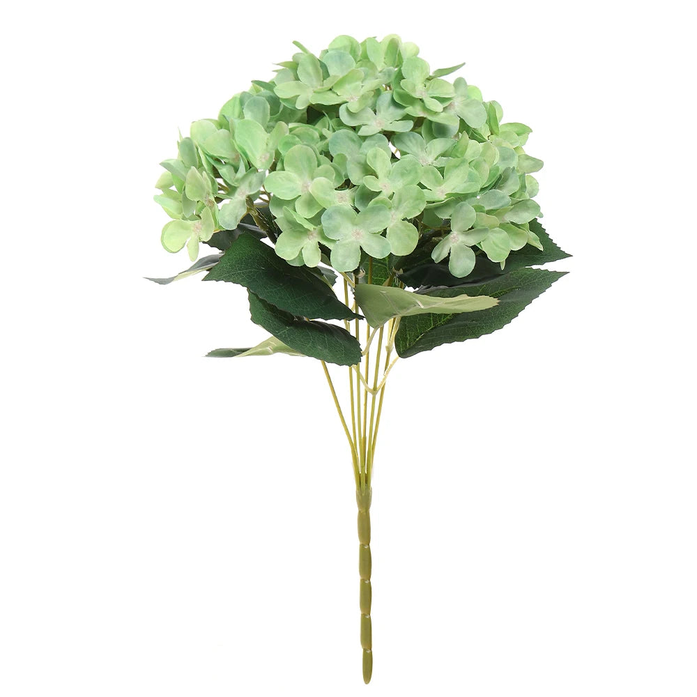 A bouquet of artificial light green hydrangea flowers with dark green leaves on a slender stem.