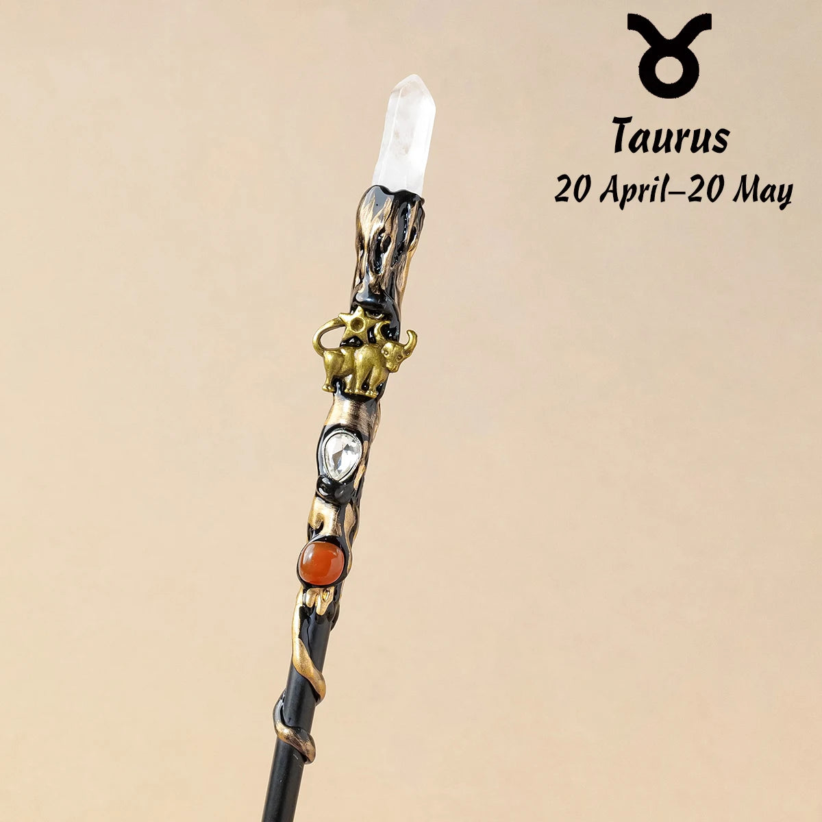 A natural clear quartz zodiac crystal wand featuring a gold-colored animal charm and an orange bead.