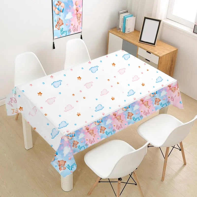White tablecloth with pink and blue clouds and stars for a gender reveal party
