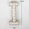 A rhinestone patch shaped like the letter T, featuring pearl and clear stones, measuring 4.5cm high and 2cm wide.