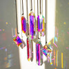A set of seven iridescent crystal prism sun catchers hanging by thin black strings.