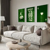 A modern living room features a light sofa and green framed art prints with gold lettering on a white wall.