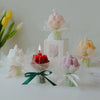 A display of artisan tulip bouquets in various pastel colors, including pink and yellow, set against a white background.