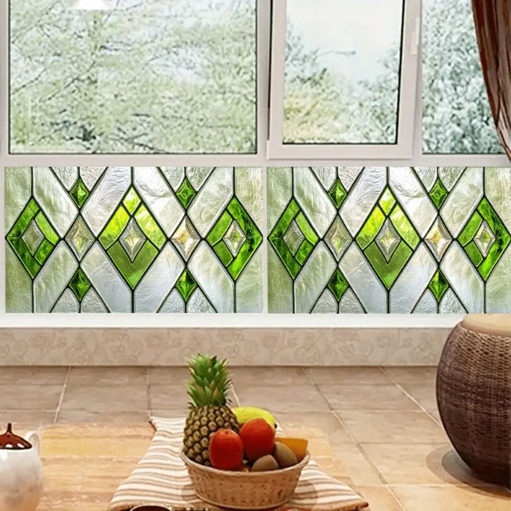A close-up view of retro European green leaf privacy window film displayed in a window frame.