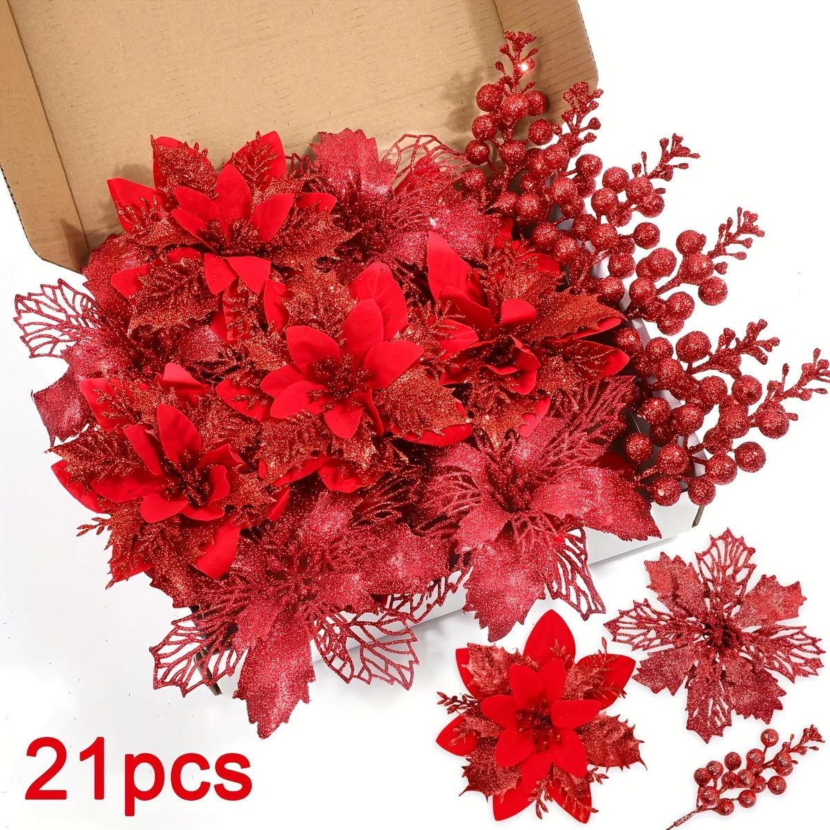 A bouquet of artificial red and deep pink flowers and berries displayed in a cardboard box.