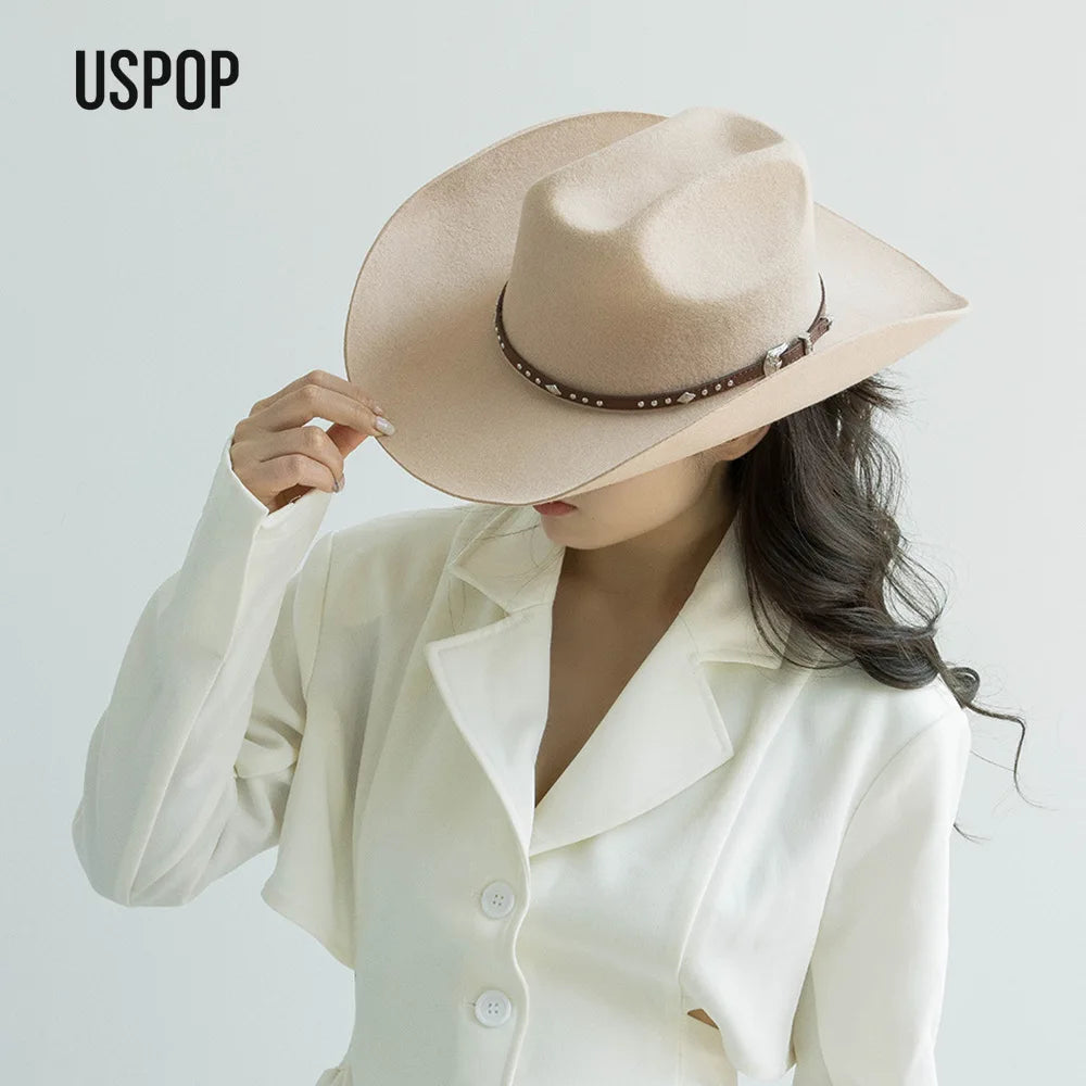 A woman wearing a beige classic wool cowboy hat with a studded leather band and a white blazer.