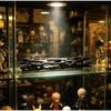A black 3D printed wishing willow stick with a breakable wish box displayed in a glass cabinet.