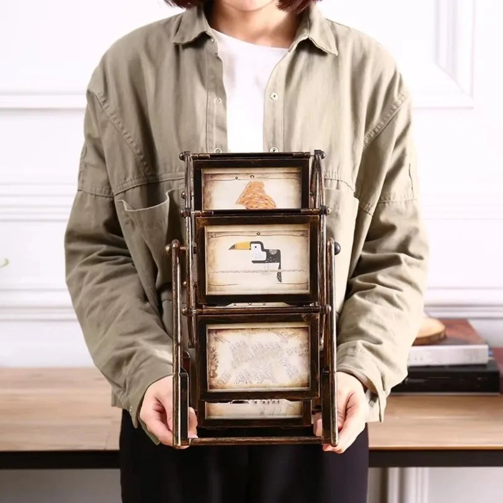 A person holds a dark wooden rotating photo frame with twelve display slots.