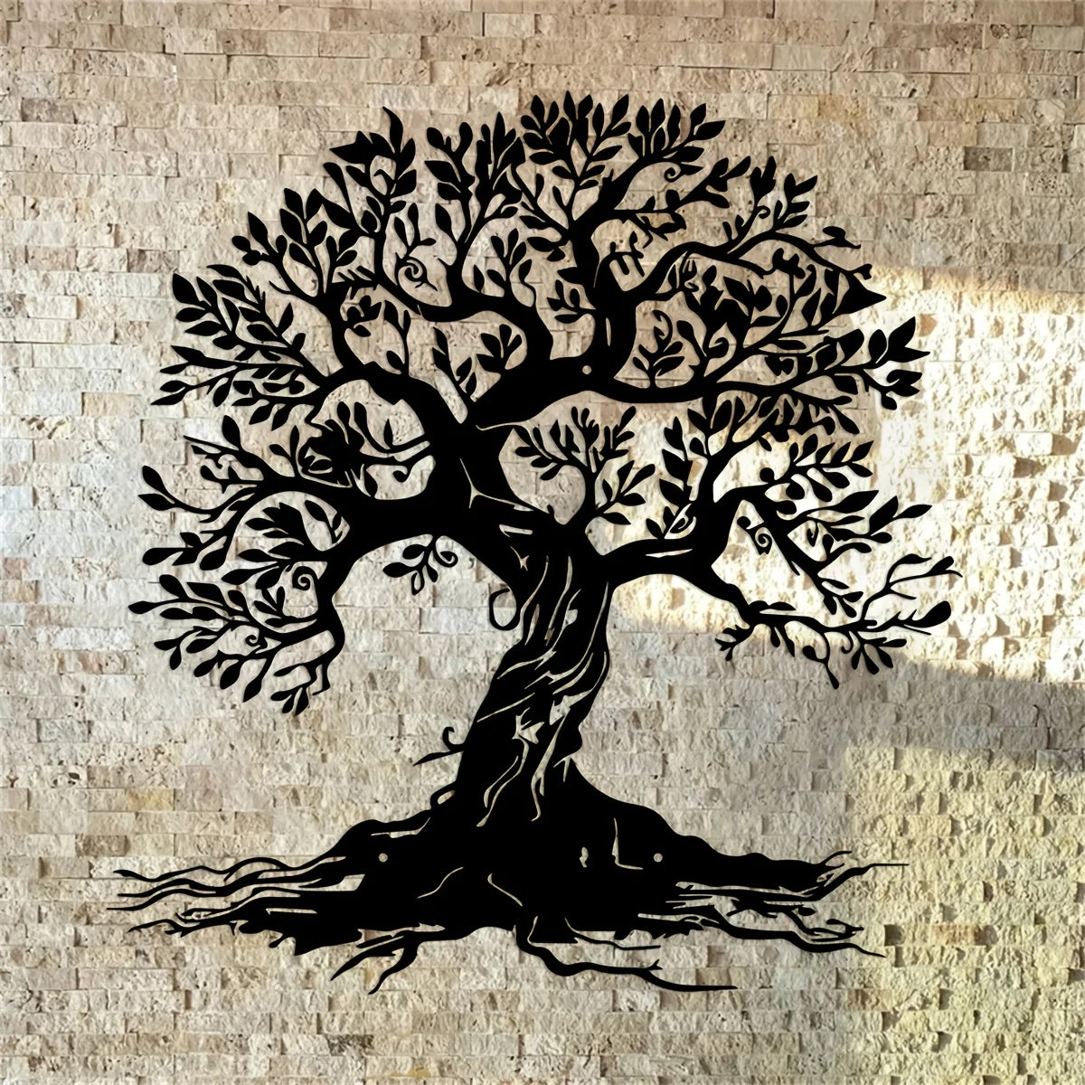 Black silhouette of a large tree with roots against a light stone wall.