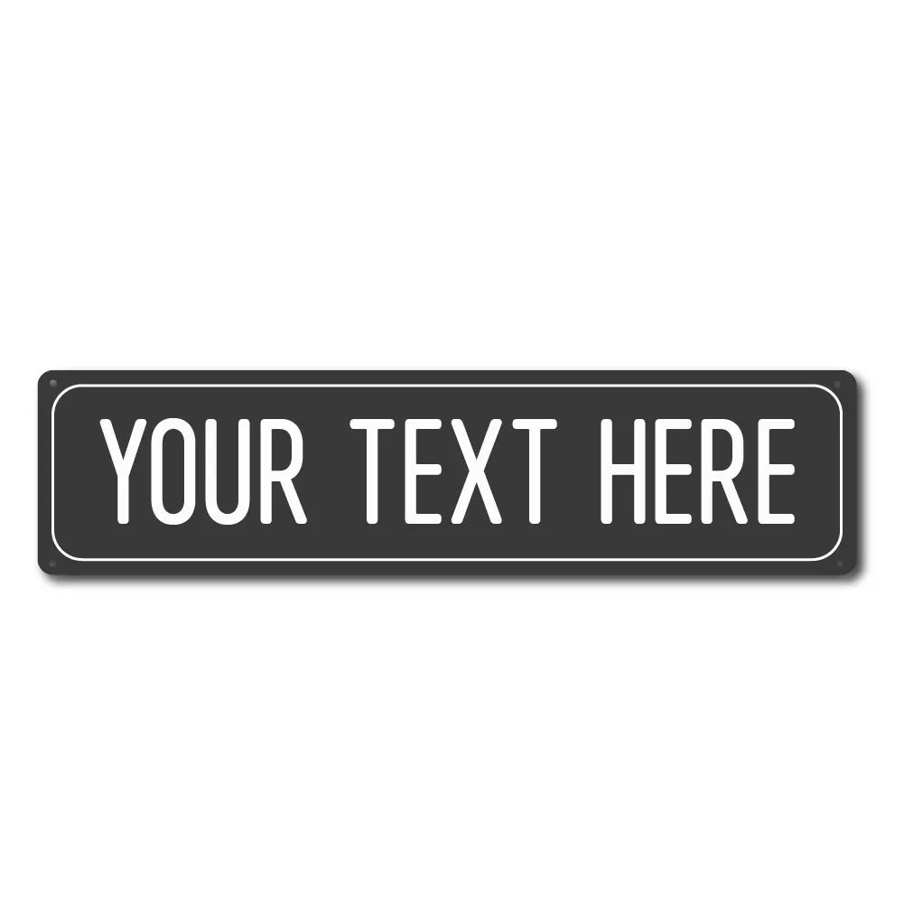 A rectangular black metal street sign with the text YOUR TEXT HERE engraved on it.