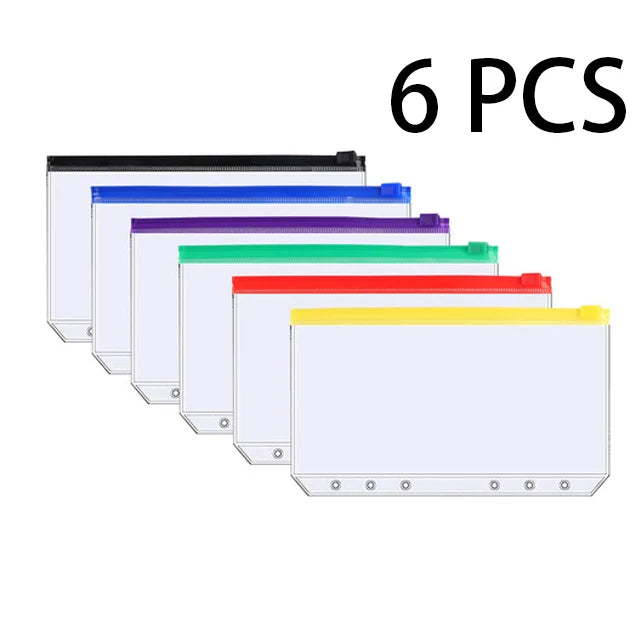 Six clear plastic budget planner binders with colored covers and cash envelopes