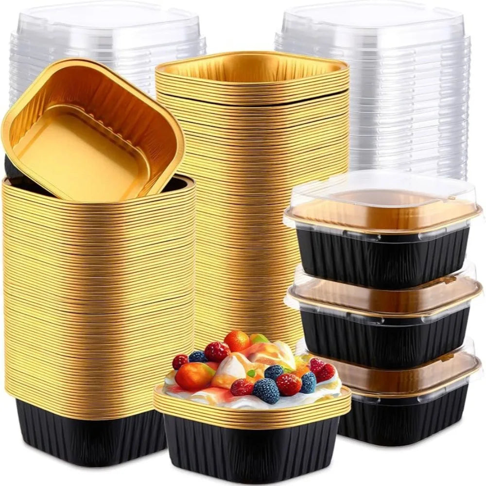 Stack of square aluminum foil baking boxes with transparent lids in gold and black.
