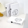 A set of three modern decorative fake books in white featuring the text Our Story This Is Our Life and Our Home.