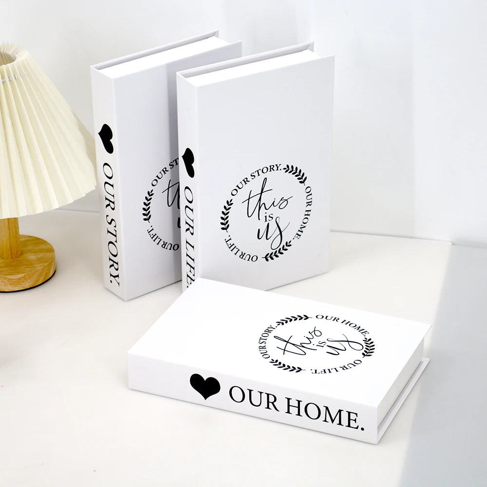 A set of three modern decorative fake books in white featuring the text Our Story This Is Our Life and Our Home.