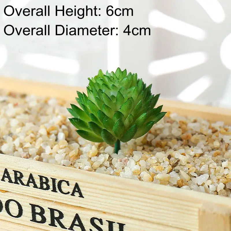 A small green artificial succulent bonsai ball is placed in a wooden box filled with light-colored gravel.