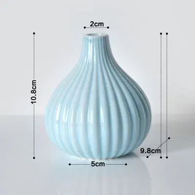 Light blue ceramic flower vase with vertical ribbed texture.