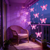 LED butterfly curtain lights hanging in a purple-lit balcony setting