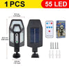 A black solar-powered motion sensor LED security light with a remote control and multiple light heads.