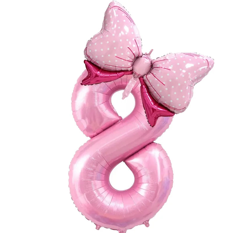 Pink foil balloon shaped like the number 8 with a bow decoration