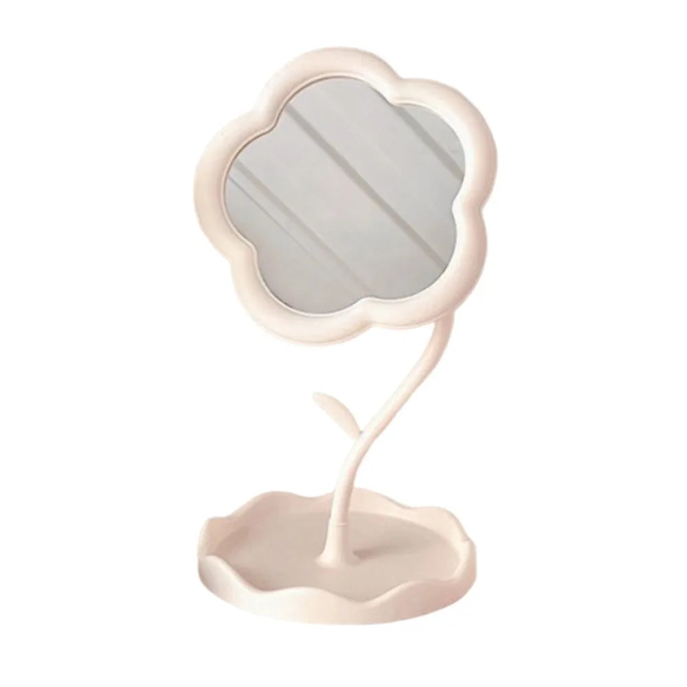 A light pink makeup mirror shaped like a sunflower heart with a scalloped frame.